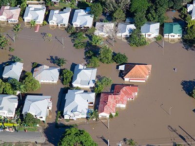 aerial view of the rooves of houses in brown floodwater